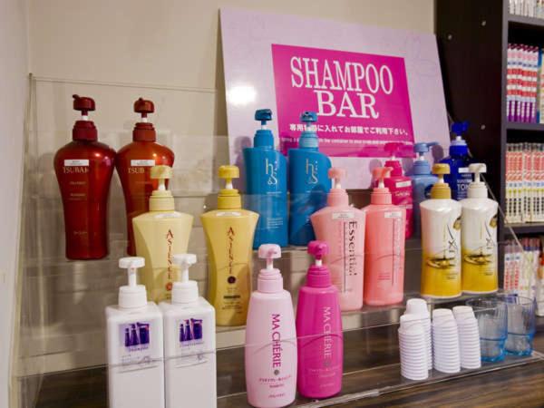 a shelf with a bunch of shampoo and soap bottles at Hotel Hillarys in Osaka