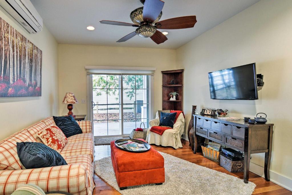 a living room with a couch and a ceiling fan at Northwest Michigan Duplex half Mi to Lake Michigan in Charlevoix