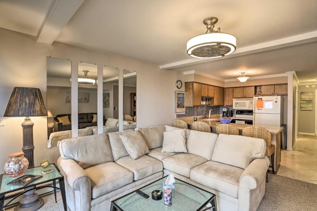 a living room with a couch and a table at The Shores Condo with Beach Access Less Than 2 Mi to Dtwn! in Port Clinton