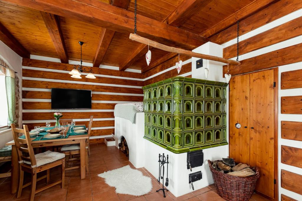 a bedroom with a bed and a desk in a room at Chalupa Na peci in Želnava