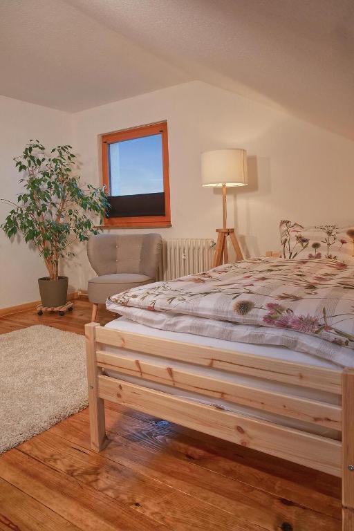a bedroom with a large bed and a window at Ferienwohnung “Mount Meißner” in Germerode