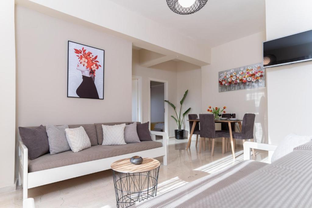 a living room with a couch and a table at Helios Residence in Chania Town