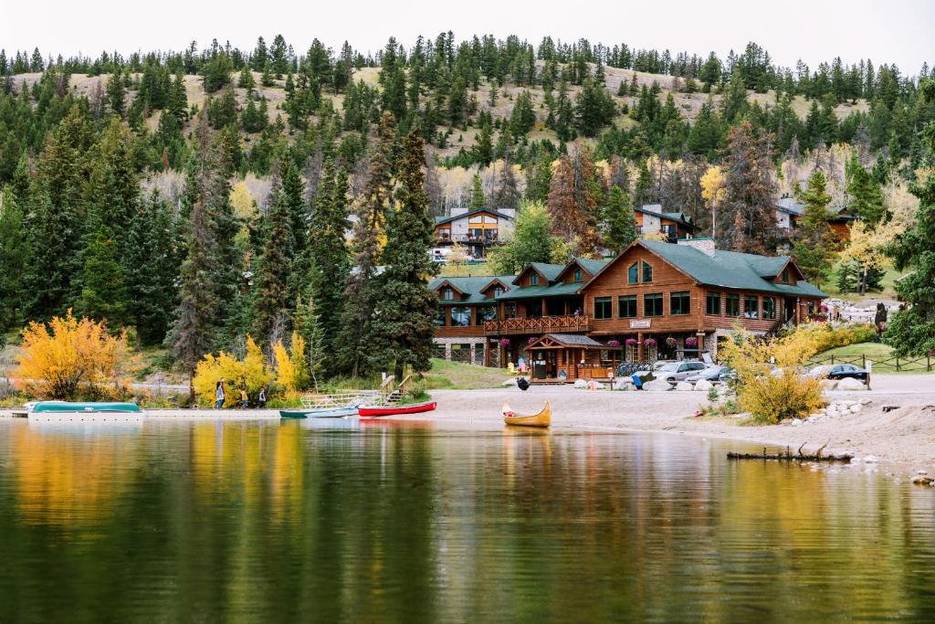 a lodge on the shore of a lake with boats in the water at Pyramid Lake Lodge in Jasper