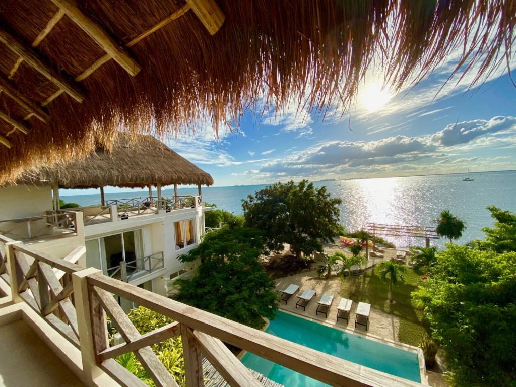 a view of the ocean from the balcony of a resort at Casa Coco by Coco B Isla in Isla Mujeres
