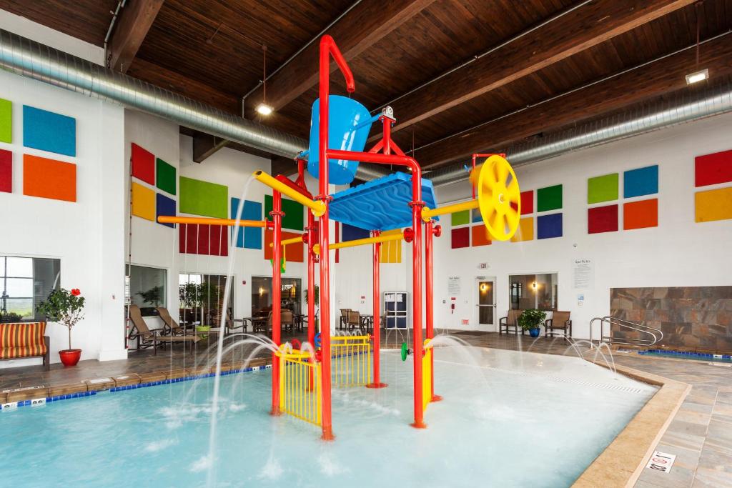 an indoor pool with a water slide in a building at Holiday Inn Express & Suites Rapid City by IHG in Rapid City