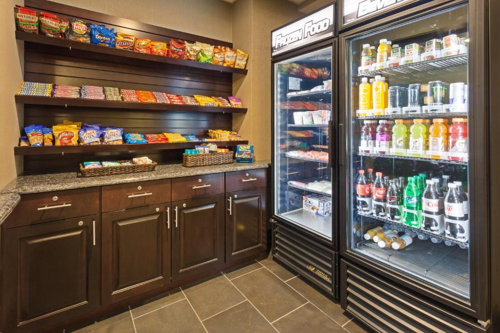 a kitchen with a large refrigerator and lots of food at Holiday Inn Express & Suites Rapid City by IHG in Rapid City