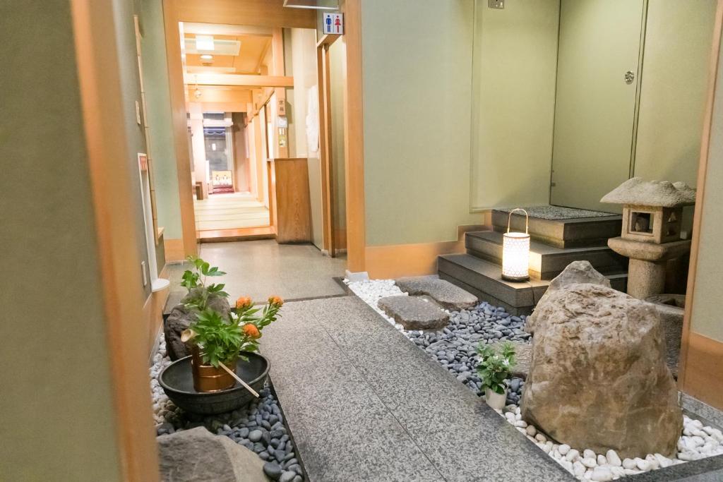 a hallway with a rock garden in a building at Kyonoyado Kagihei in Kyoto