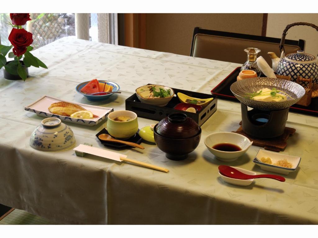 a table topped with bowls of food and chopsticks at Kyonoyado Kagihei in Kyoto