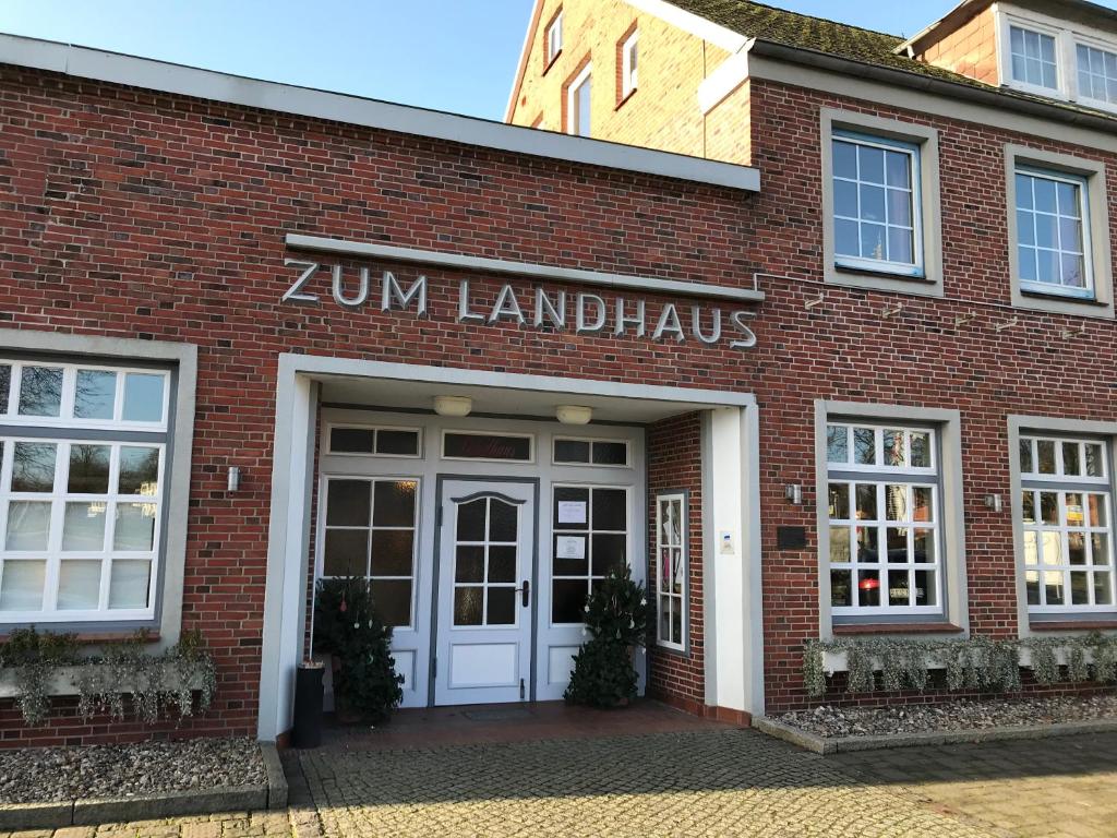 a red brick building with a zim laundry sign on it at Hotel und Restaurant Landhaus Veranstaltungshaus in Hohenwestedt