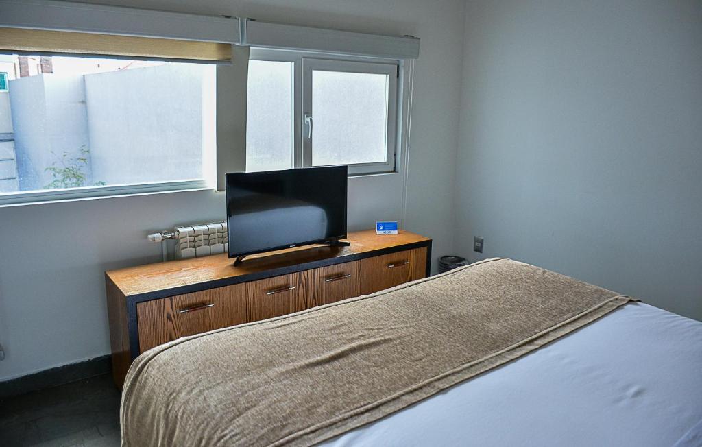 Postel nebo postele na pokoji v ubytování Natalino Hotel Patagonia