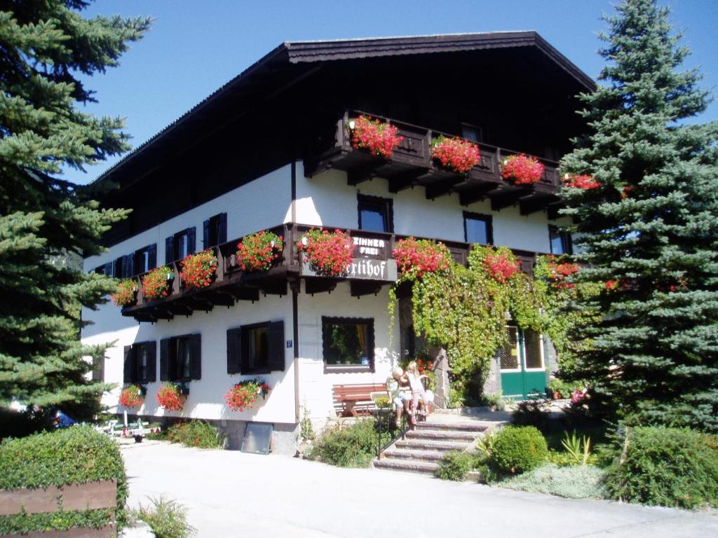 a white building with flower boxes on the balconies at Rupertihof in Fuschl am See