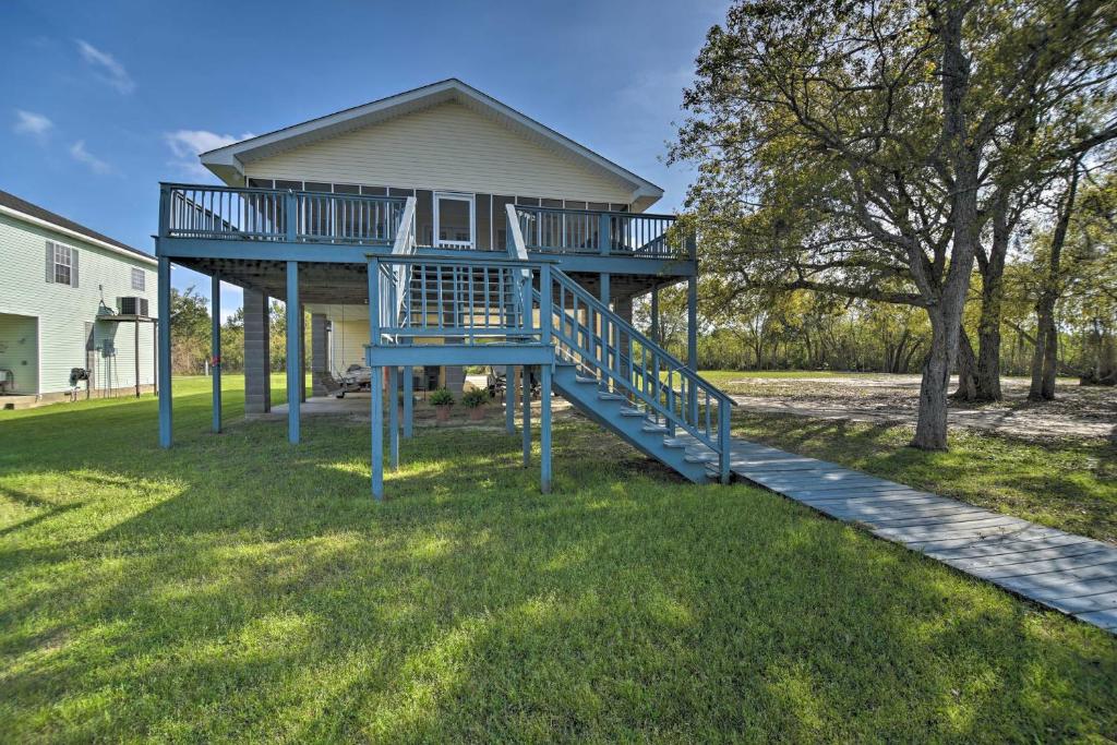 a blue staircase in front of a house at Fish at Canalfront Bay St Louis Home - Dock and Deck in Shoreline Park