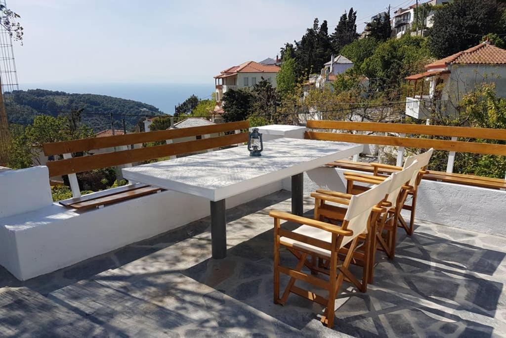 a table and chairs sitting on top of a roof at Chariklia Traditional House in Alonnisos