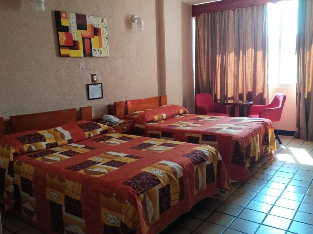 Postel nebo postele na pokoji v ubytování Hotel Cabildos
