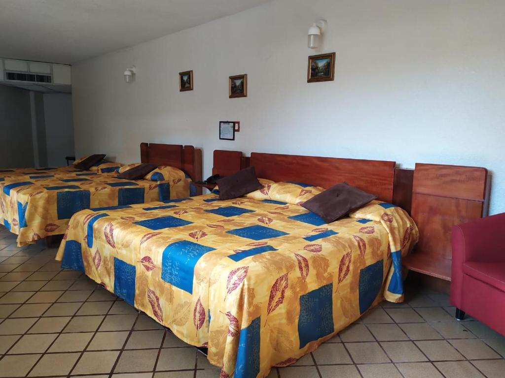 Postel nebo postele na pokoji v ubytování Hotel Cabildos