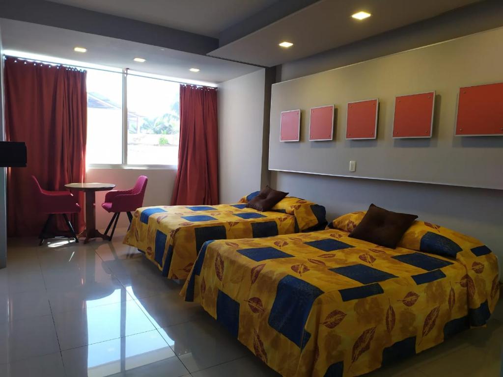 Postel nebo postele na pokoji v ubytování Hotel Cabildos