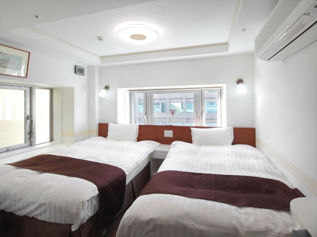 Postel nebo postele na pokoji v ubytování Check in Shijokarasuma