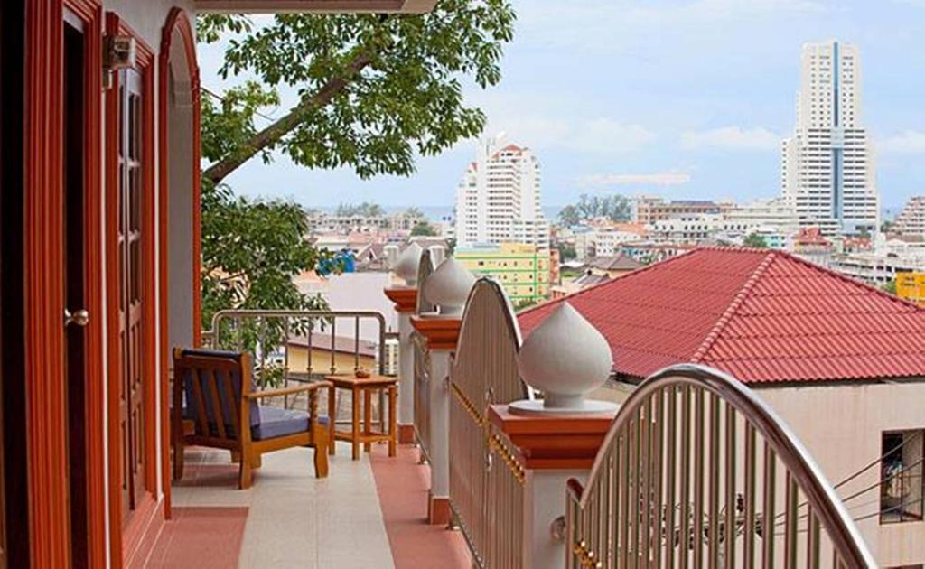 a balcony with chairs and tables and a view of a city at Grand View in Patong Beach
