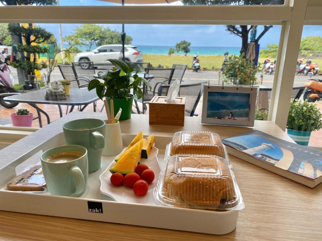 a tray of food on a table with a plate of food at LoveSea 126 Beach Inn in Kenting