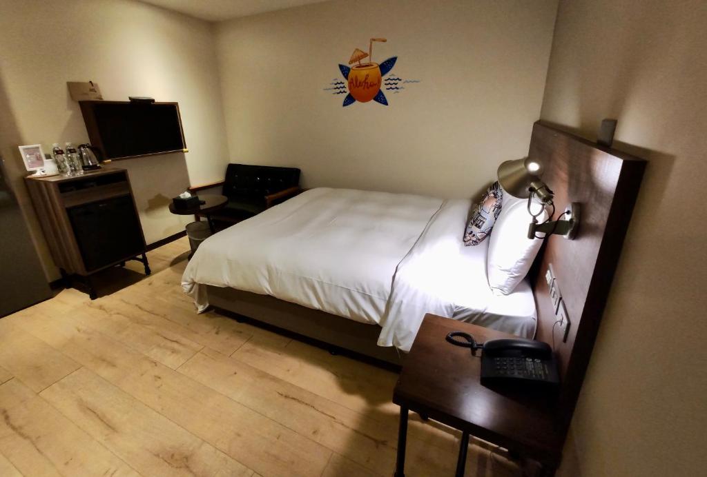 Postel nebo postele na pokoji v ubytování Just Live Inn-Keelung