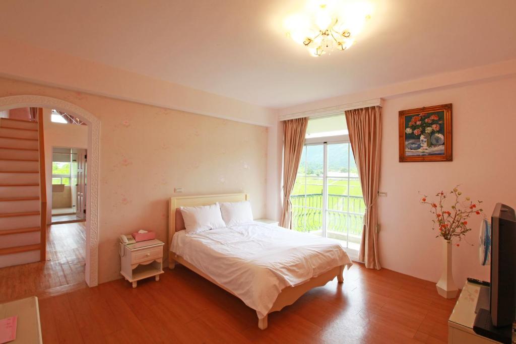 a bedroom with a bed and a large window at Sigma Castle in Yuanshan