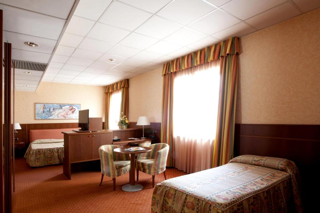 Postel nebo postele na pokoji v ubytování Palace Hotel Moderno