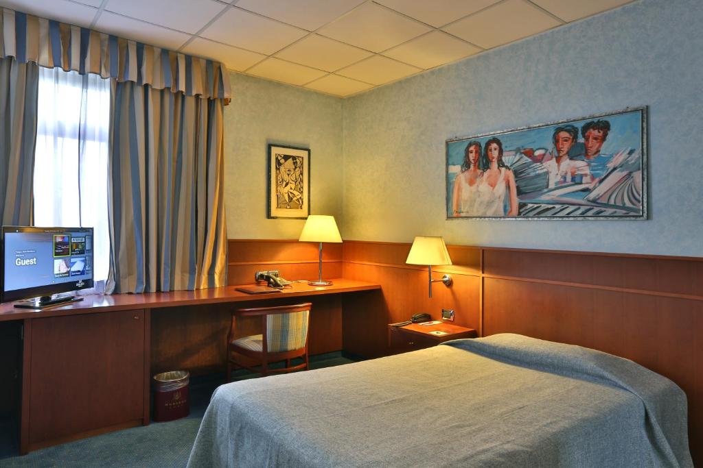 Postel nebo postele na pokoji v ubytování Palace Hotel Moderno
