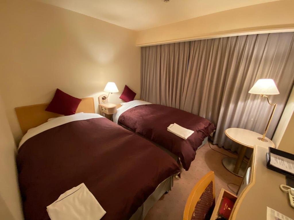 Кровать или кровати в номере Koriyama View Hotel