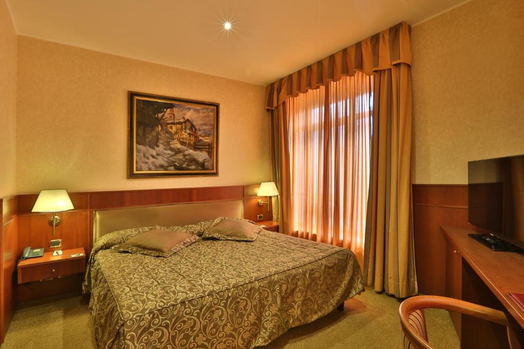Postel nebo postele na pokoji v ubytování Palace Hotel Moderno