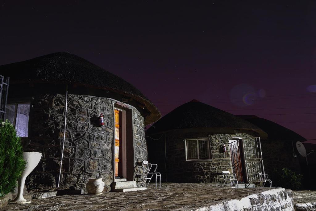 a small stone house with a doorway at night at Mants’ebo Guest House Mokhotlong in Mokhotlong