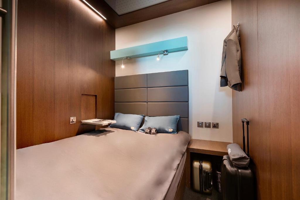 ein kleines Zimmer mit einem Bett in einem Zimmer in der Unterkunft sleep 'n fly Sleep Lounge, A-Gates Terminal 3 - TRANSIT ONLY in Dubai