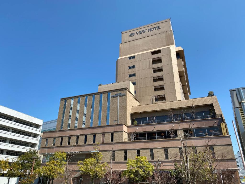 a tall building with a sign on top of it at Koriyama View Hotel in Koriyama