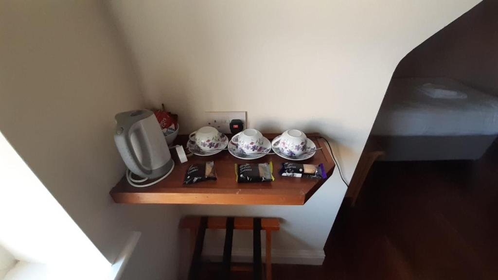 a small table with a tv and bowls on it at Inspiration Lodge in Anascaul