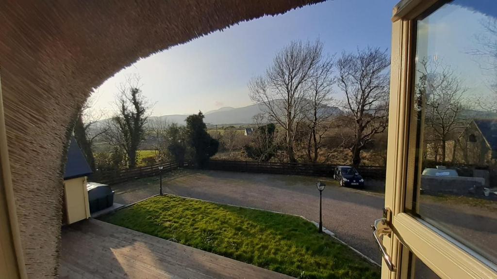 a view from a window of a yard at Inspiration Lodge in Anascaul