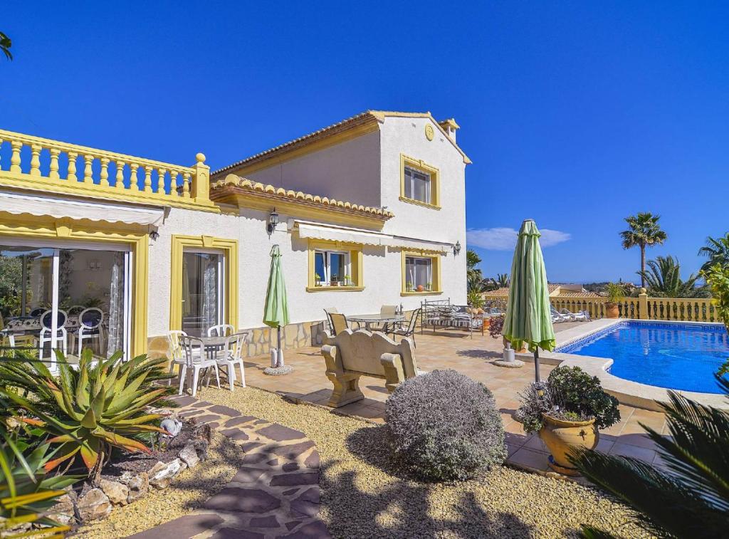 a villa with a swimming pool and a house at Villa Cometa - Plusholidays in Calpe