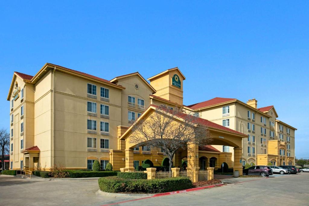 a large building with a clock on top of it at La Quinta by Wyndham DFW Airport South / Irving in Irving