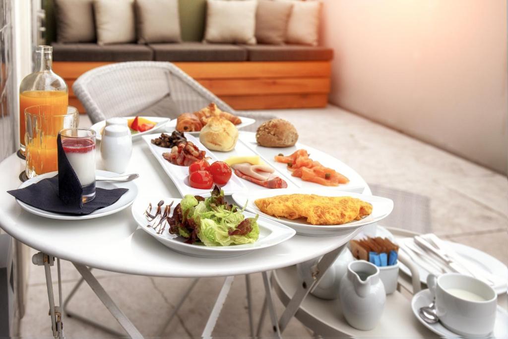 A generously styled breakfast spread on a small round table.
