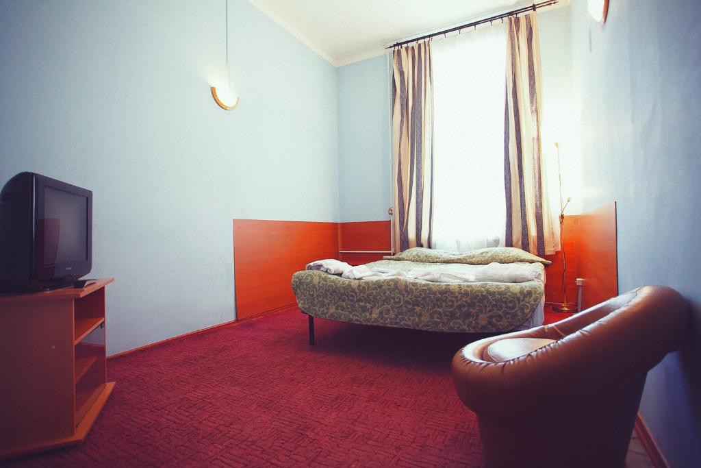 a living room with a couch and a tv at Otdykh 2 Hotel in Moscow