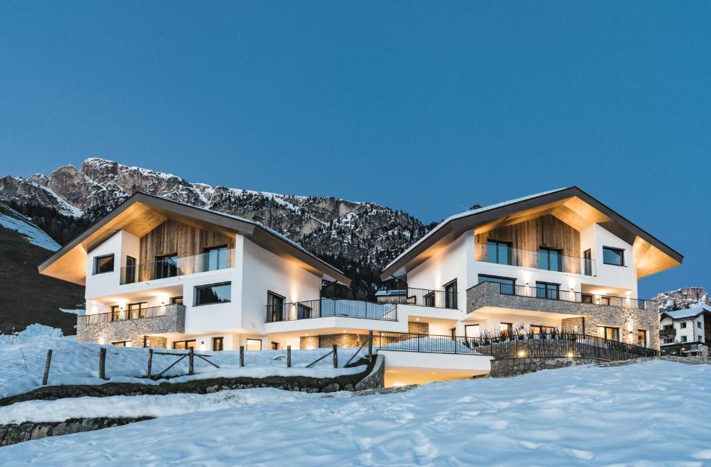 a hotel in the mountains in the snow at Aurela Mountain Chalets in Selva di Val Gardena
