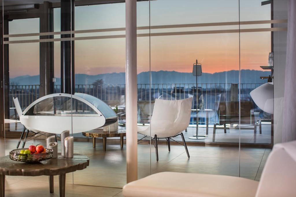 a living room with a view of a balcony at hirschen dornbirn - das boutiquestyle hotel in Dornbirn