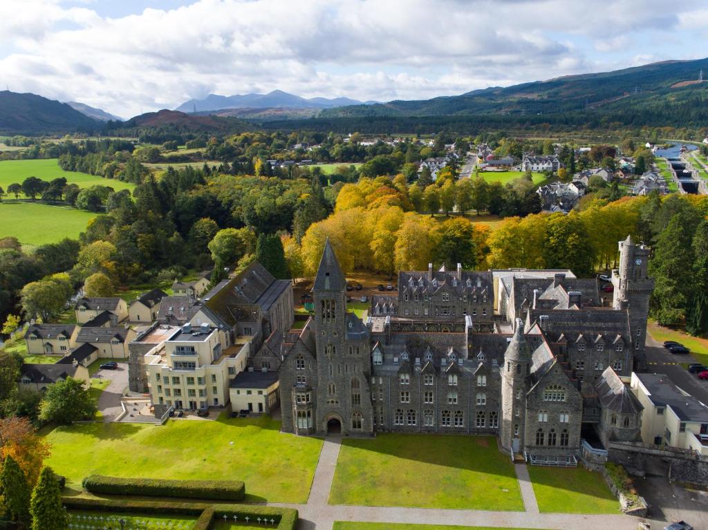 an aerial view of a castle in a city at One Bedroom Apartment Highland Club Scotland in Fort Augustus