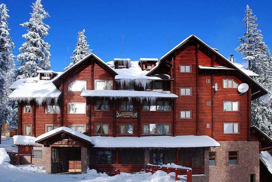 a large wooden building with snow on it at Marika in Dragobrat