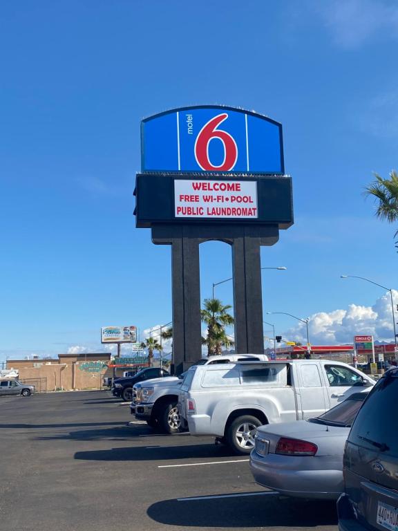 a welcome sign in a parking lot with cars at Motel 6 Bullhead City, Az - Laughlin in Bullhead City