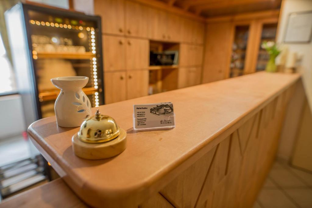 a counter in a kitchen with a vase and a price tag at Hotel Koliba in Litoměřice