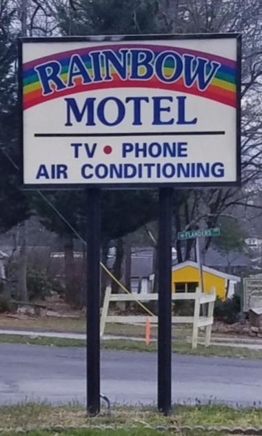 a rainbow motel sign on the side of the road at Rainbow Motel in Hendersonville