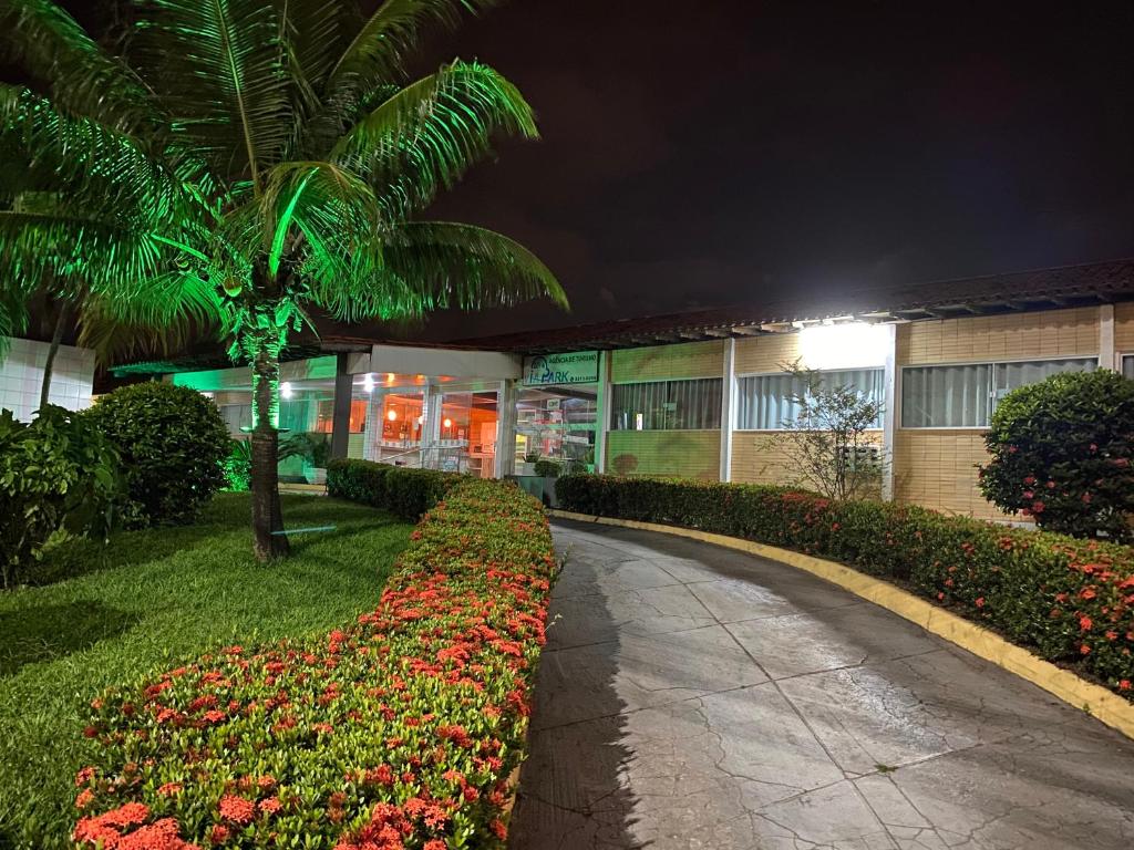 a walkway in front of a building at night at Hotel Ryad Express in São Luís