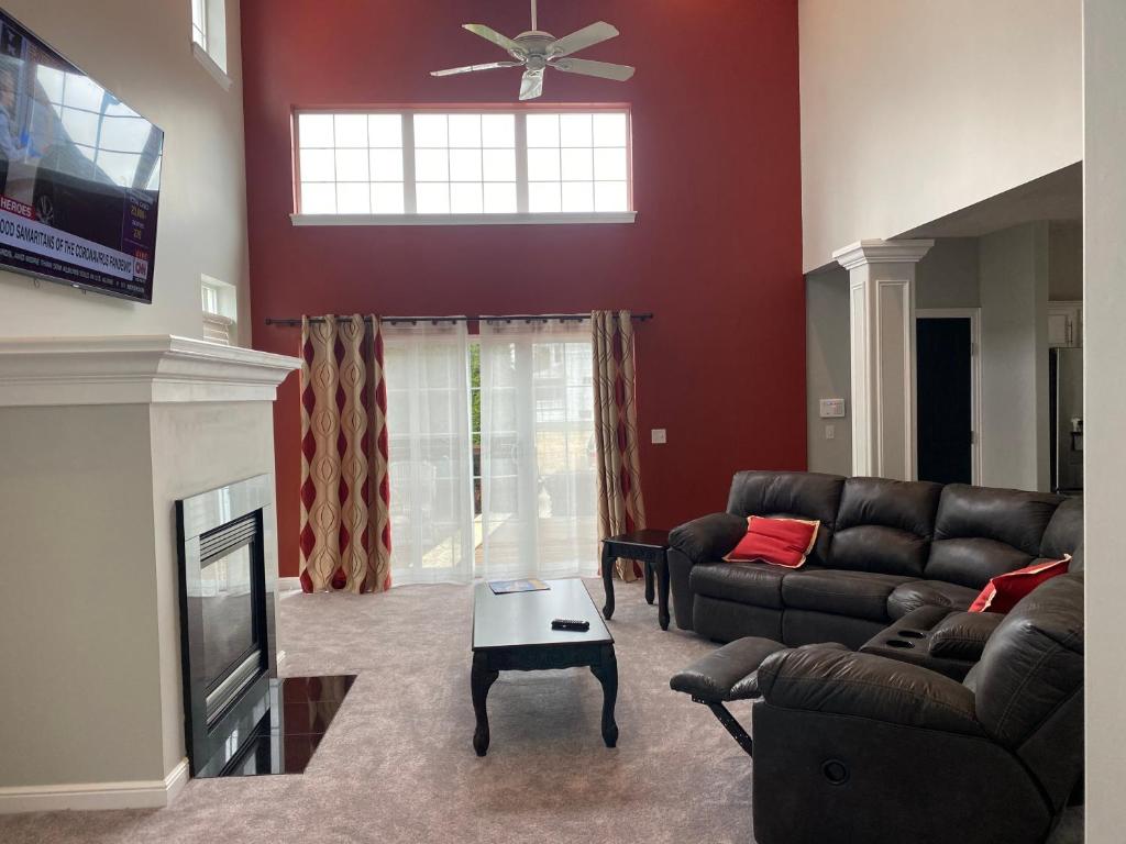 a living room with a couch and a fireplace at The La Grange House in Cleveland