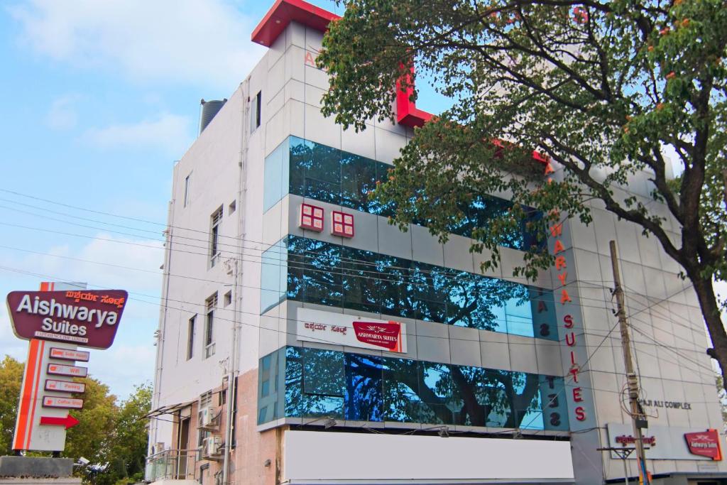 a building with glass windows on the side of it at Aishwarya Suites in Mysore