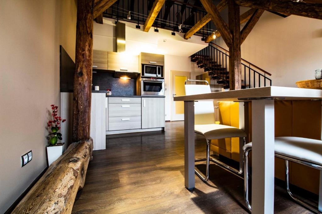 a kitchen and living room with a table and chairs at Residence U Černé Věže České Budějovice in České Budějovice