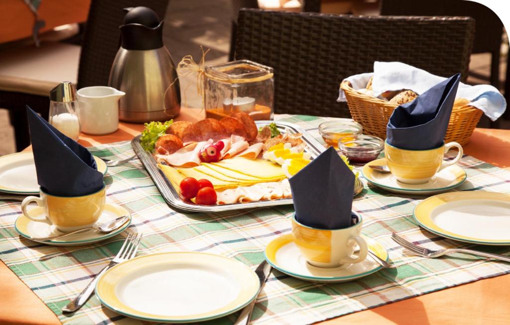 una mesa con un plato de comida con sombreros de peregrino en Pension Kranzmayr, en Sankt Wolfgang